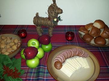 Yule supper of sausage, cheese, bread, apples, walnuts, and hazel nuts (filberts).